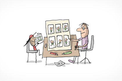 Assis à une table et se faisant face: un enfant lit une BD et un dessinateur de BD nous montre la planche de BD qu'il vient de dessiner.